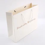 Custom Logo Cardboard Bolsas Apparel White Boutique Retail Carry Luxury Packaging Gift Paper Bag for Small Business - 画像 (2)